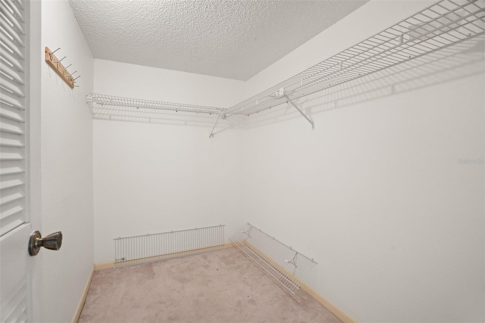 Storage Made Simple. Ample shelving and hanging space in the primary bedroom walk-in closet make it easy to stay organized.