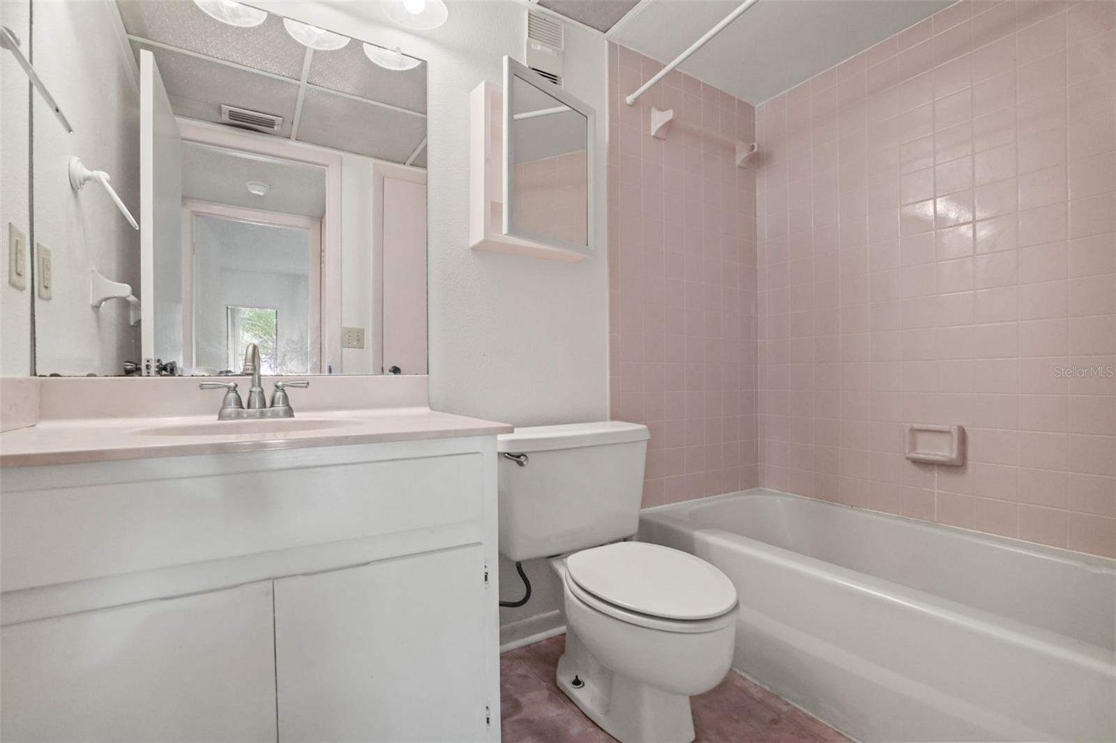 Secondary bathroom with single vanity and tub/shower combo.
