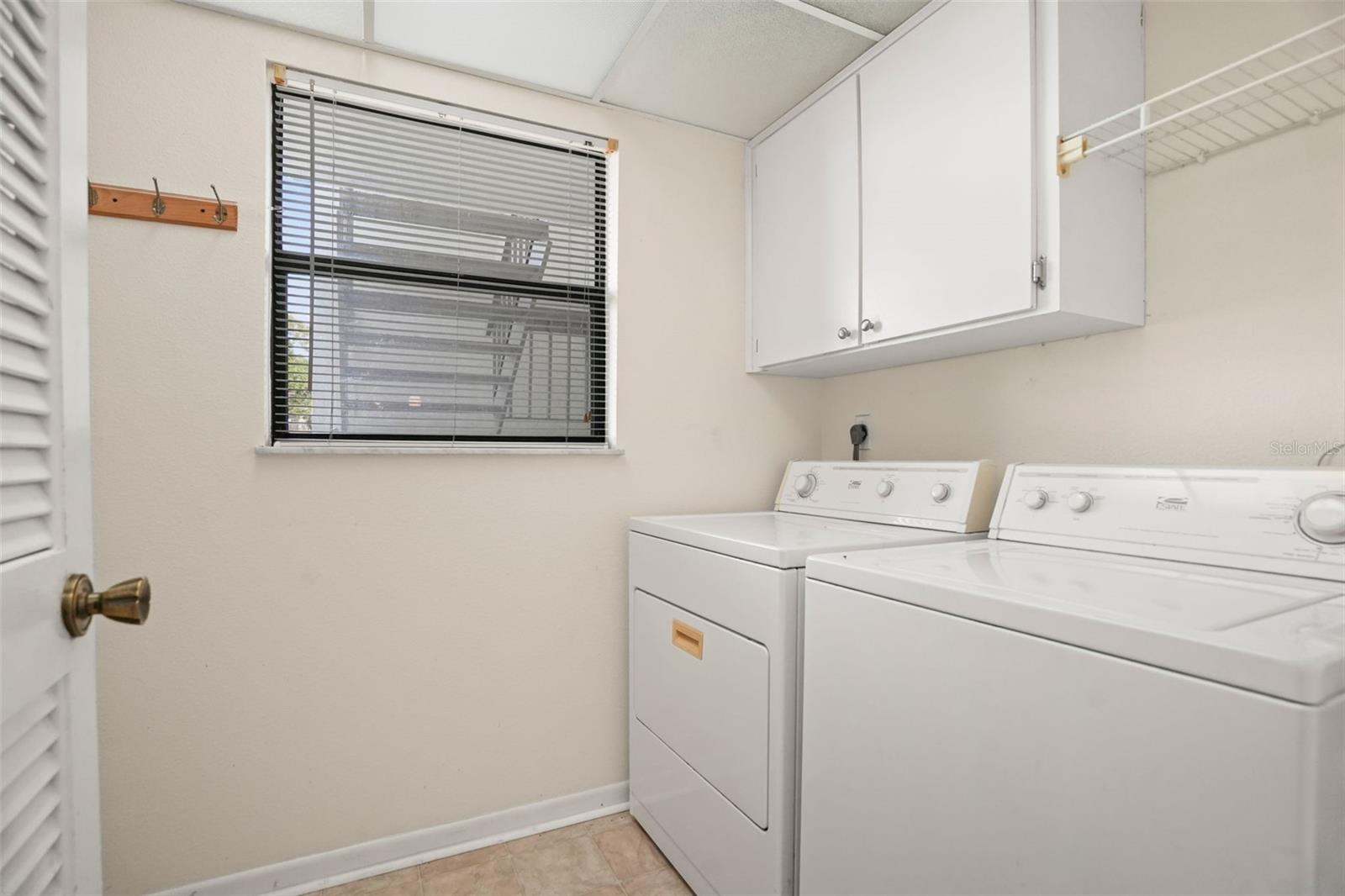 A Laundry Room of Its Own. Complete with a window, overhead storage, and space for full-size appliances, it's a practical feature not found in every condo.
