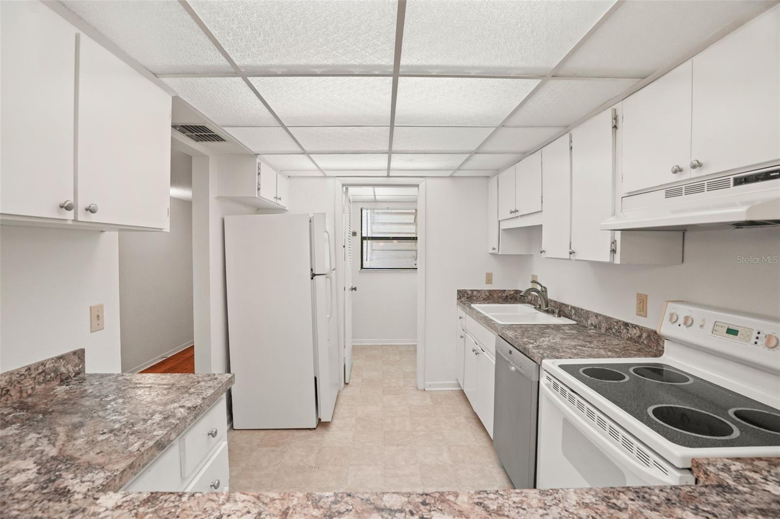 Room to Spread Out. Cabinetry and counter space line both sides of the kitchen, while the wide breakfast bar opens the space to the dining and living areas.