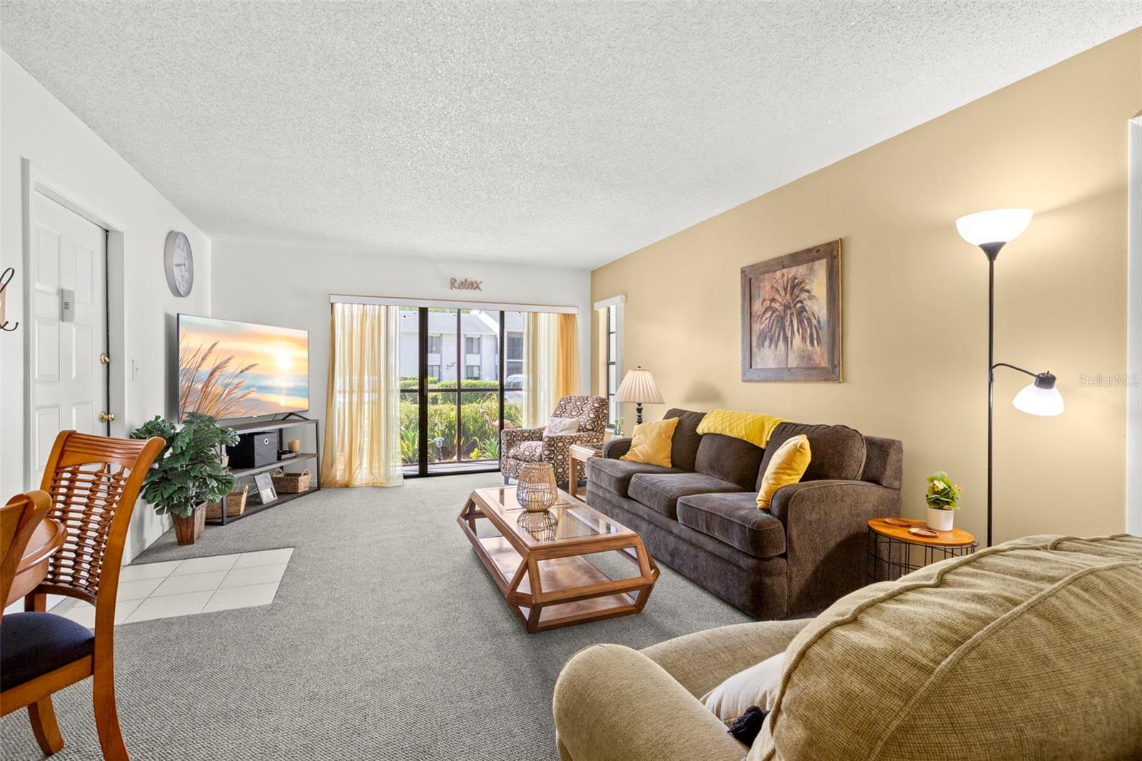 Natural light, comfortable gathering spaces, and an open layout make this living room feel welcoming from the moment you step inside.