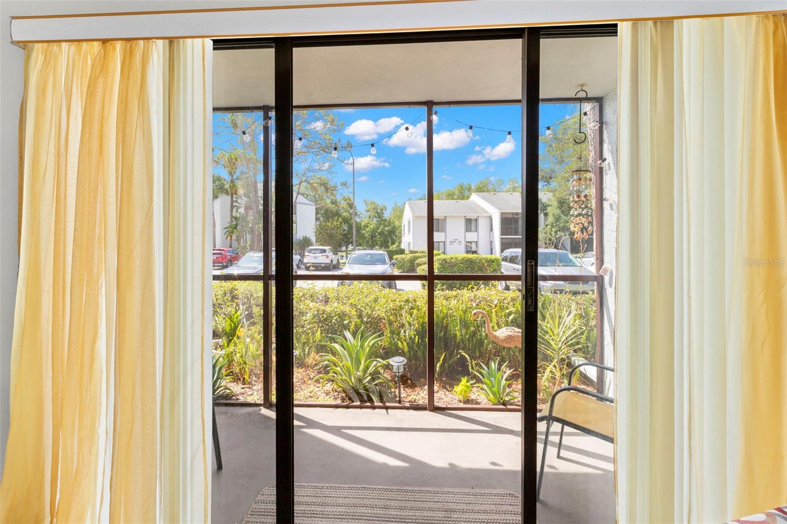 Sliding glass doors create a seamless connection to the screened porch while filling the living area with natural light.