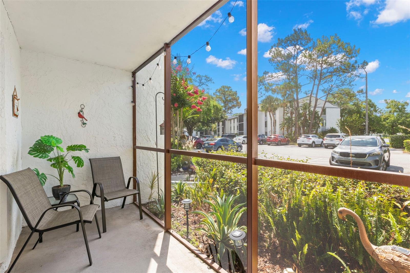 A screened porch extends the living space outdoors, creating a comfortable spot to relax while overlooking the landscaped grounds.