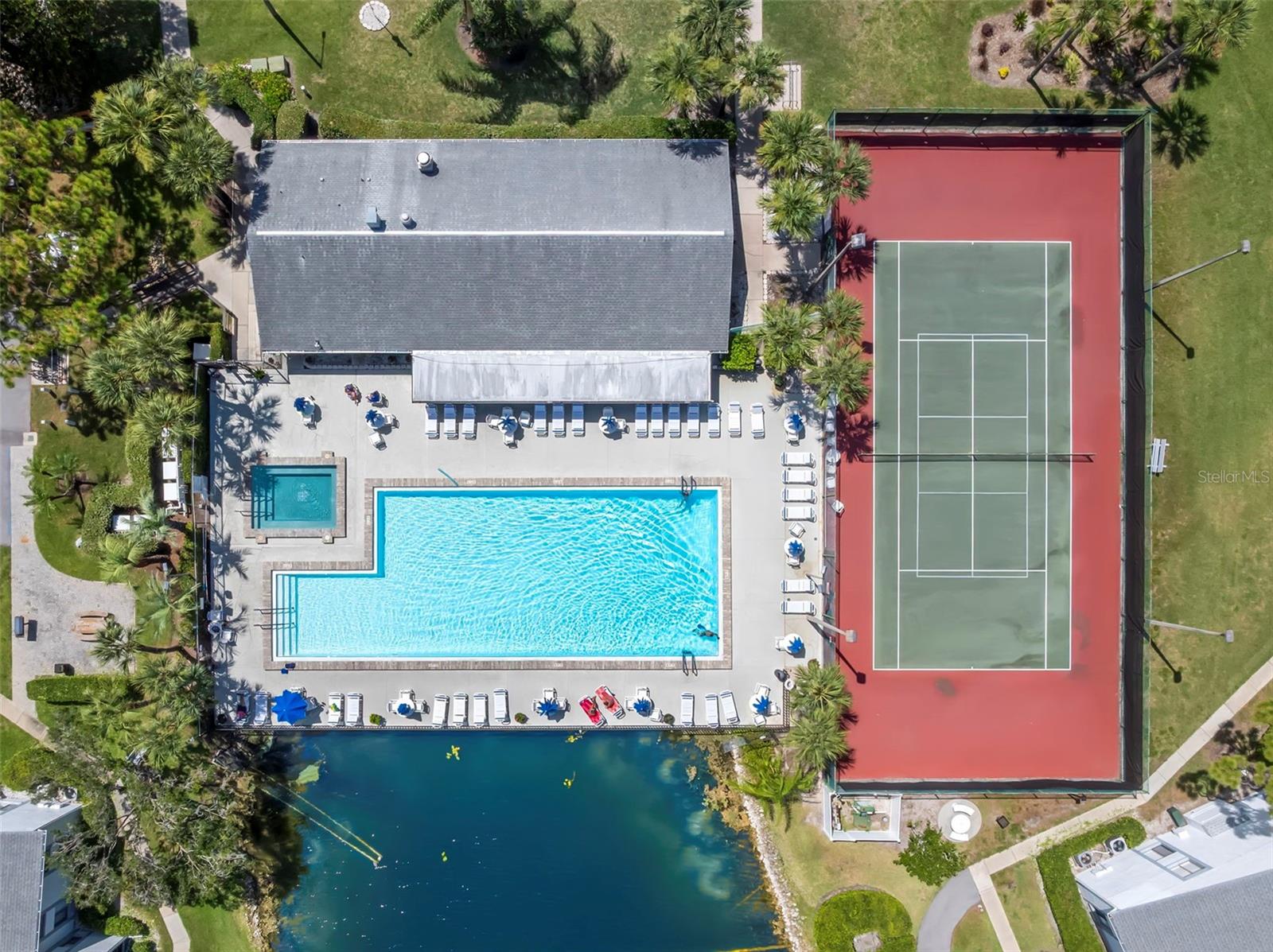Resort-style amenities include a heated pool and spa overlooking the lake, tennis courts, and a clubhouse—all surrounded by beautifully maintained grounds.