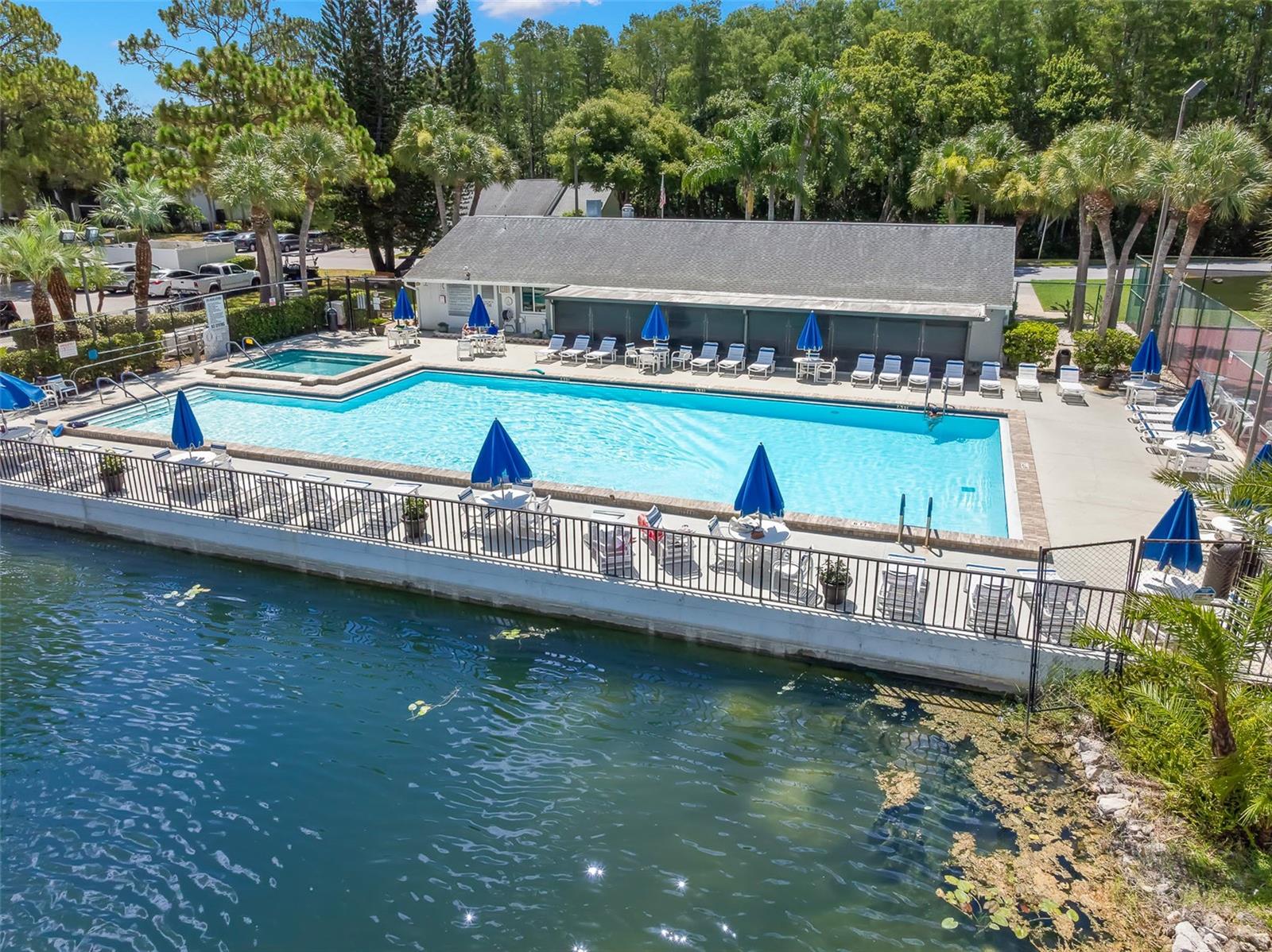 The heated pool and spa overlook a scenic community lake, creating a beautiful place to swim, unwind, and soak up the Florida sunshine.