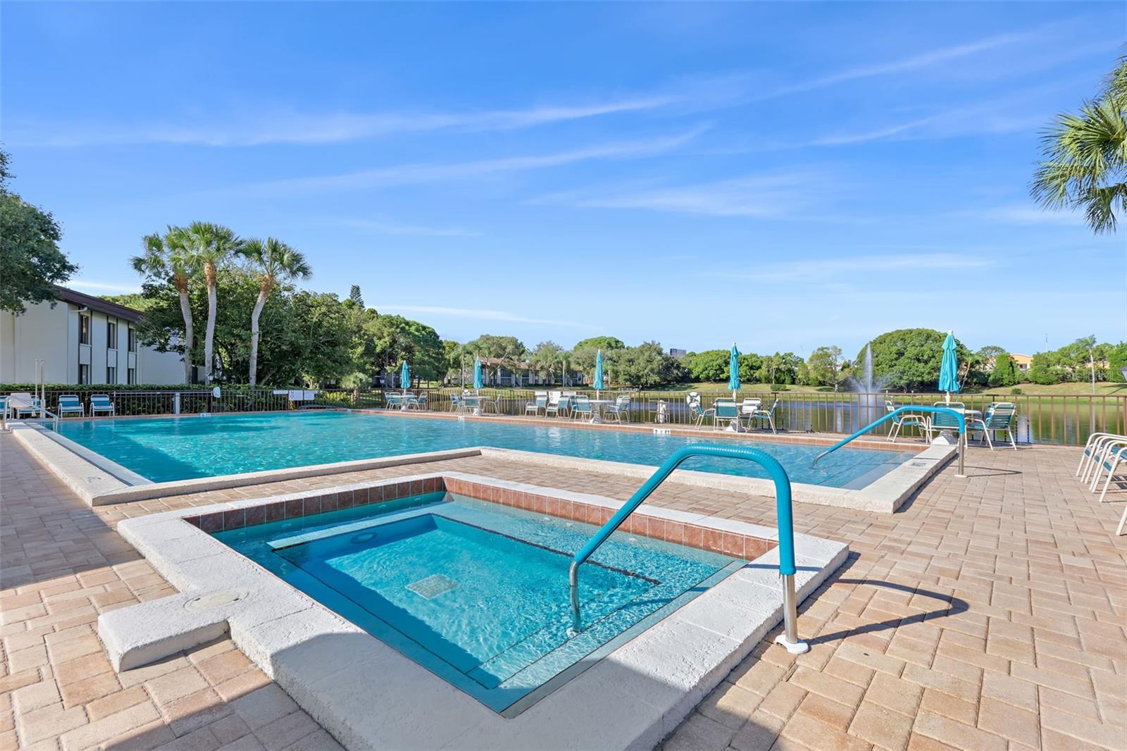 Relax in the heated spa, cool off in the pool, and enjoy tranquil lake views from the expansive paver pool deck.