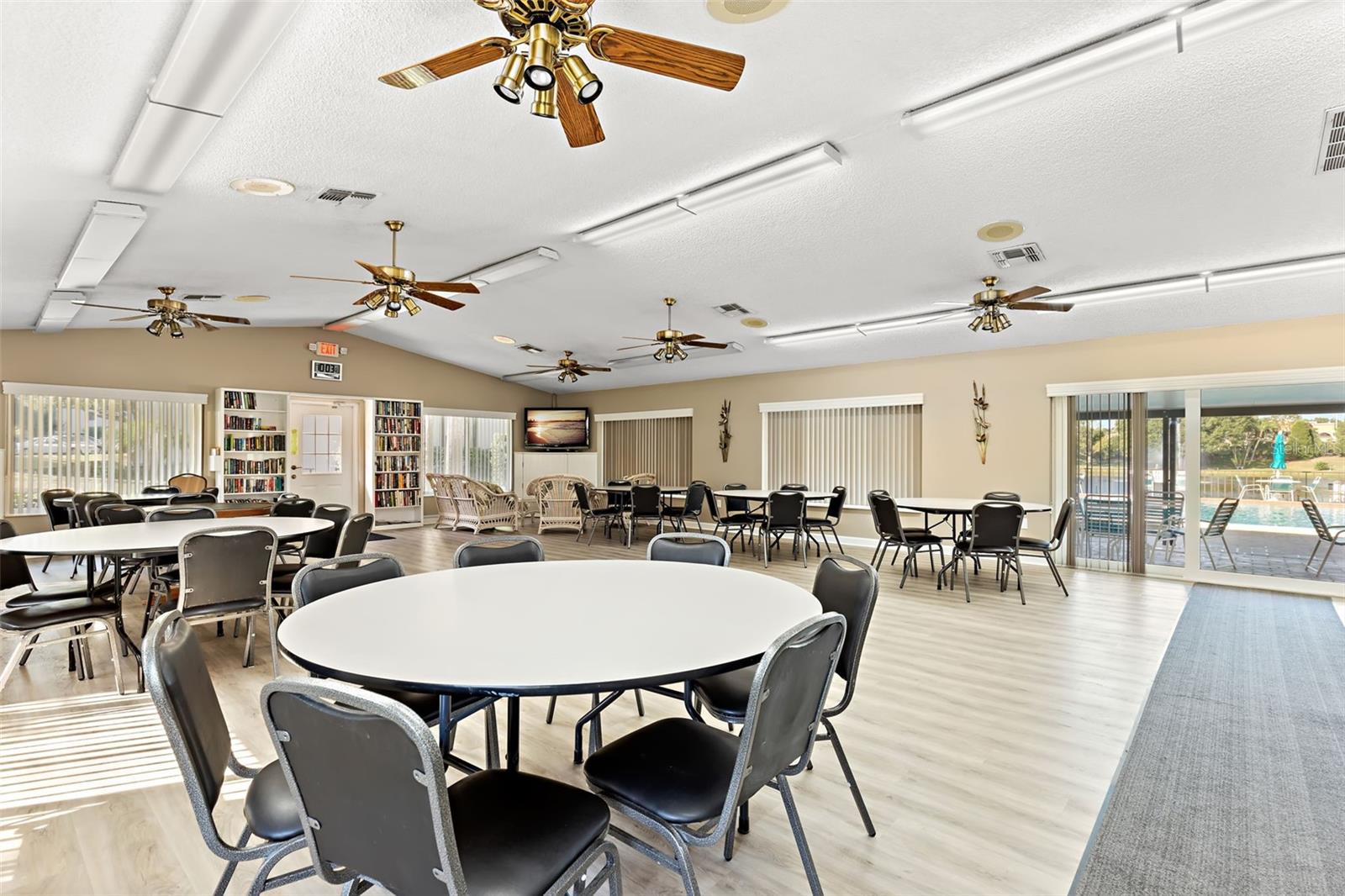 The spacious clubhouse offers a welcoming place to gather with neighbors, host events, or enjoy community activities overlooking the lake.