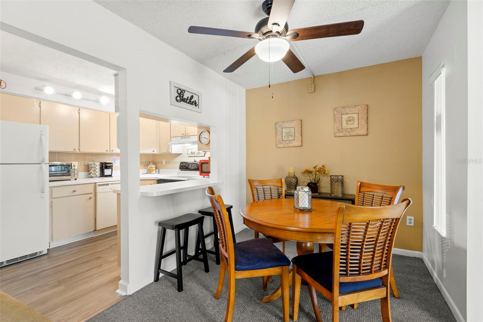 The dining area comfortably accommodates a table for four and sits beside the breakfast bar, creating an easy connection to the kitchen.