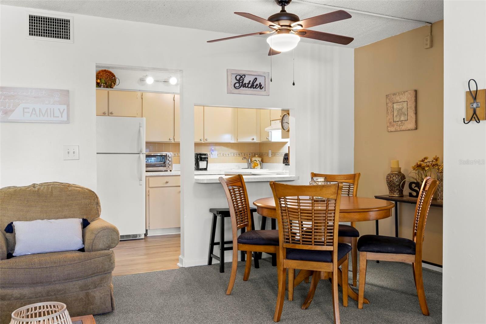 The dining area sits just outside the kitchen, with a breakfast bar that keeps the spaces connected while adding casual seating.