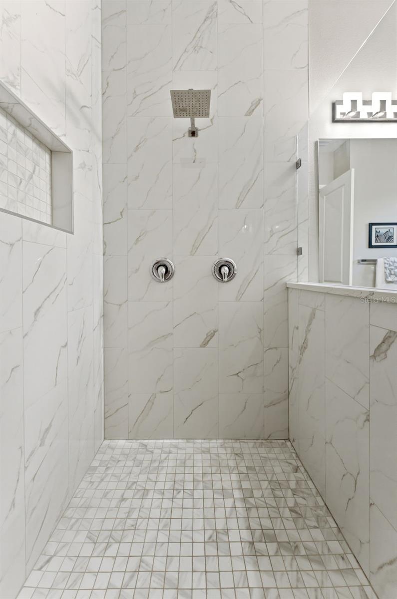 Large Primary Ensuite Walk-In Shower with frameless glass door and rainfall showerhead