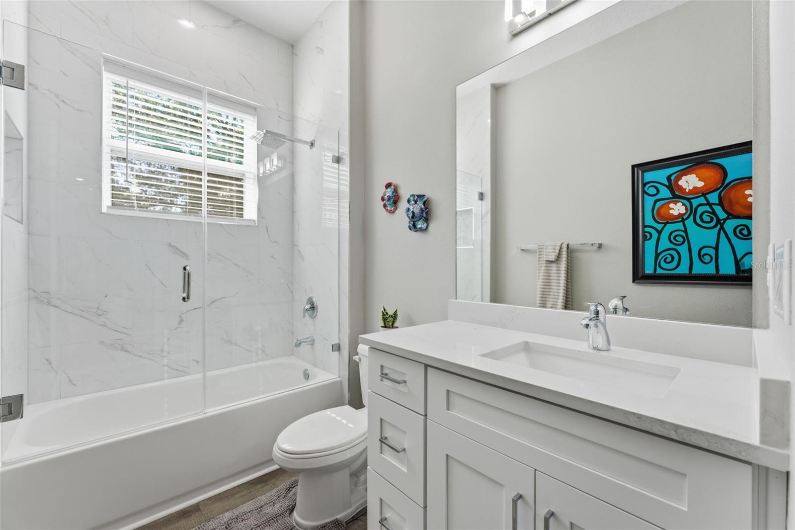 Full Bathroom Upstairs with a soaking tub, frameless glass doors and rainfall showerhead