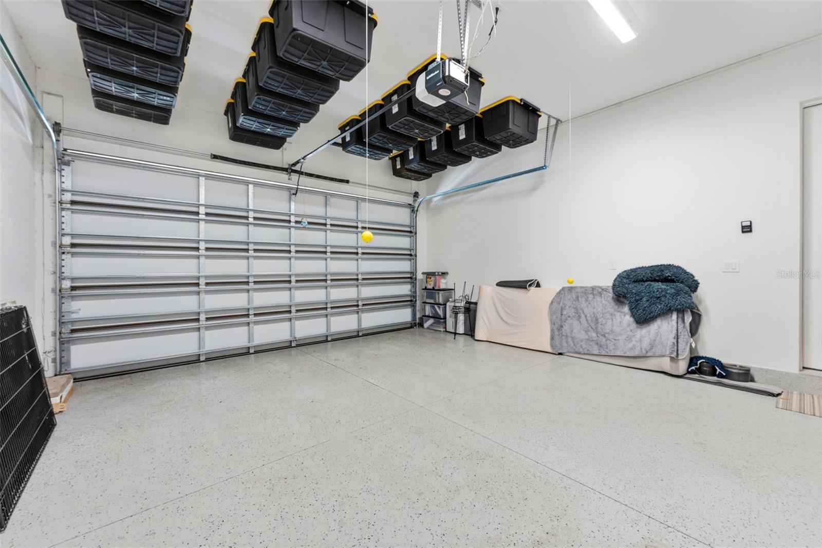 Attached 2-Car Garage with an epoxy-coated floor and built-in ceiling storage system