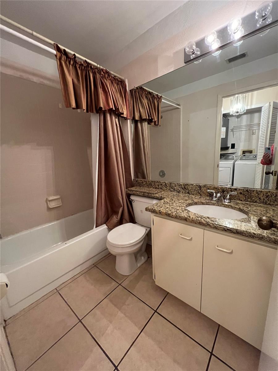 Hall bathroom, shower and tile are clean and in good condition.