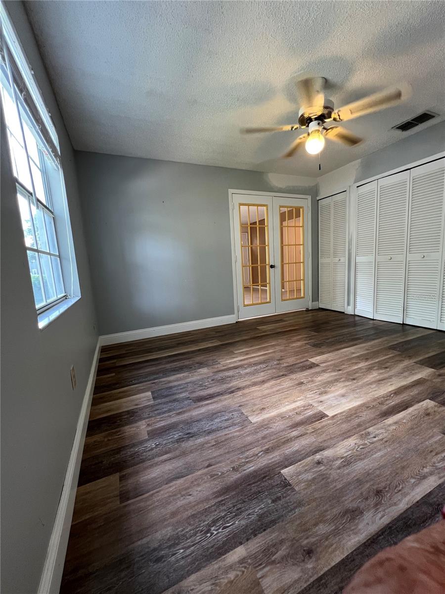 View from door to the screened patio towards french door of 2nd bedroom/office.