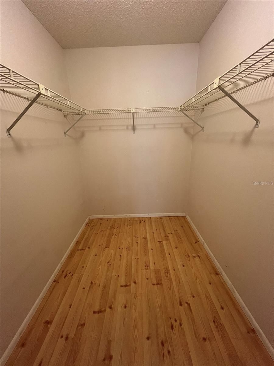 Walk in closet in primary bedroom.