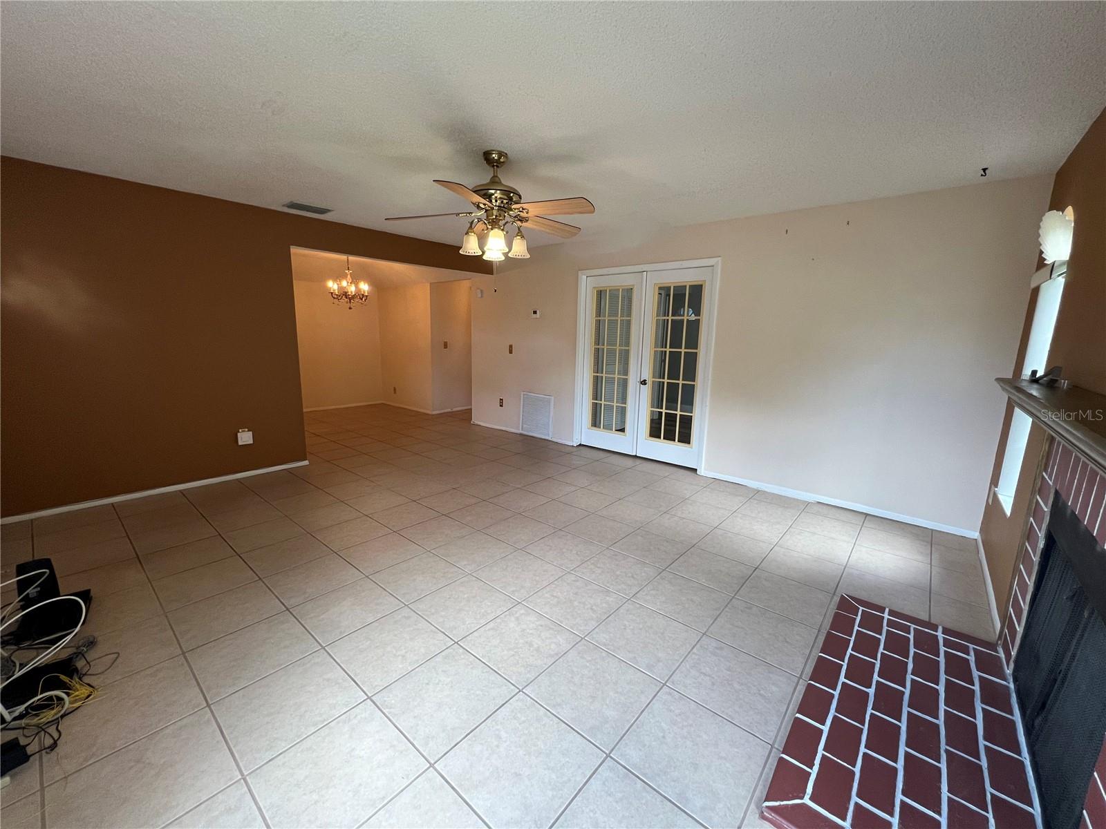 View from living room by fireplace towards 2nd bedroom/office and dining.