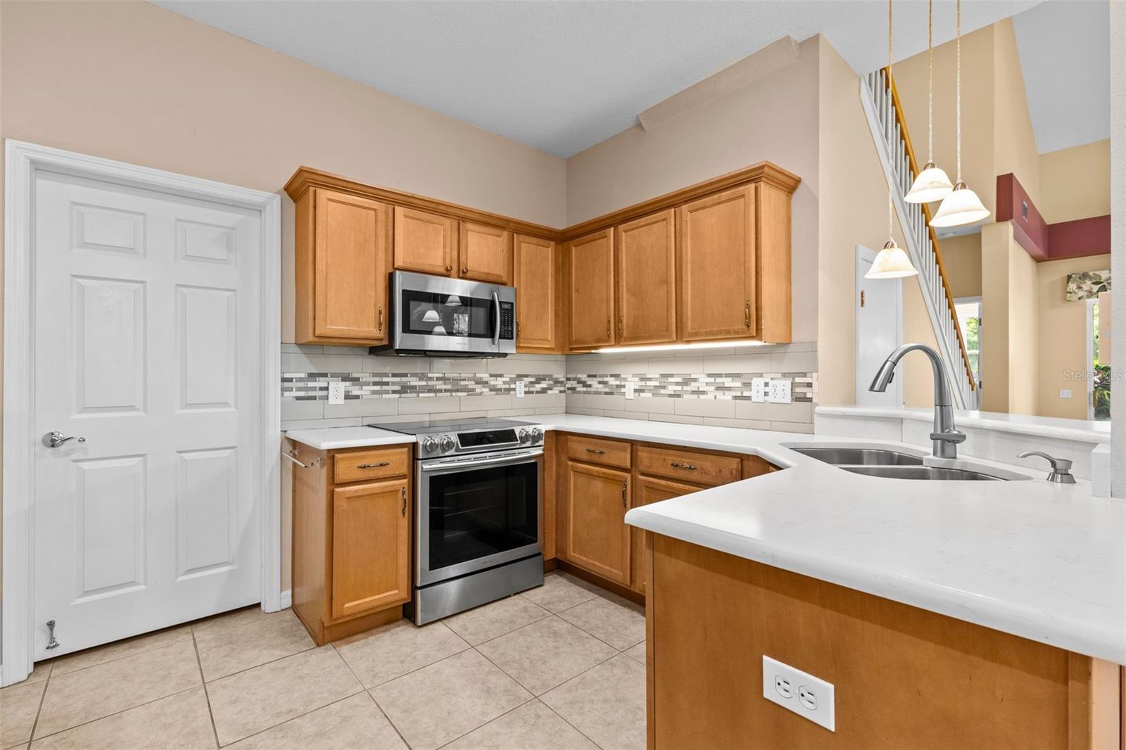 Upgraded solid surface counters and tile backsplash
