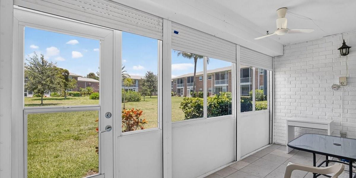 View from large, enclosed Florida room/lanai w/ electric storm shutters