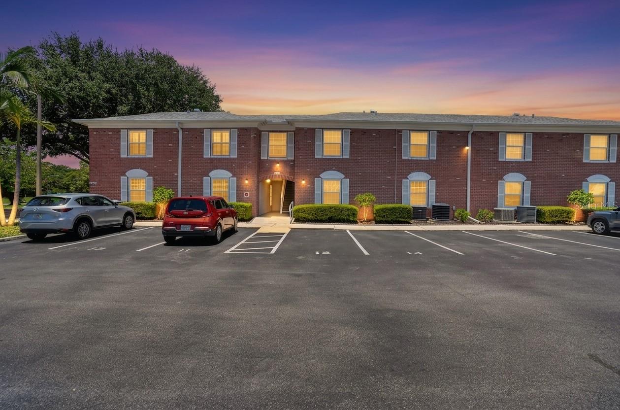 Condo building in twilight.  In contrast to many St. Pete communities, Patriot Square has plenty of guest parkin available.