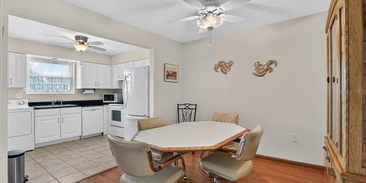 Another view of dining room with open kitchen on left.