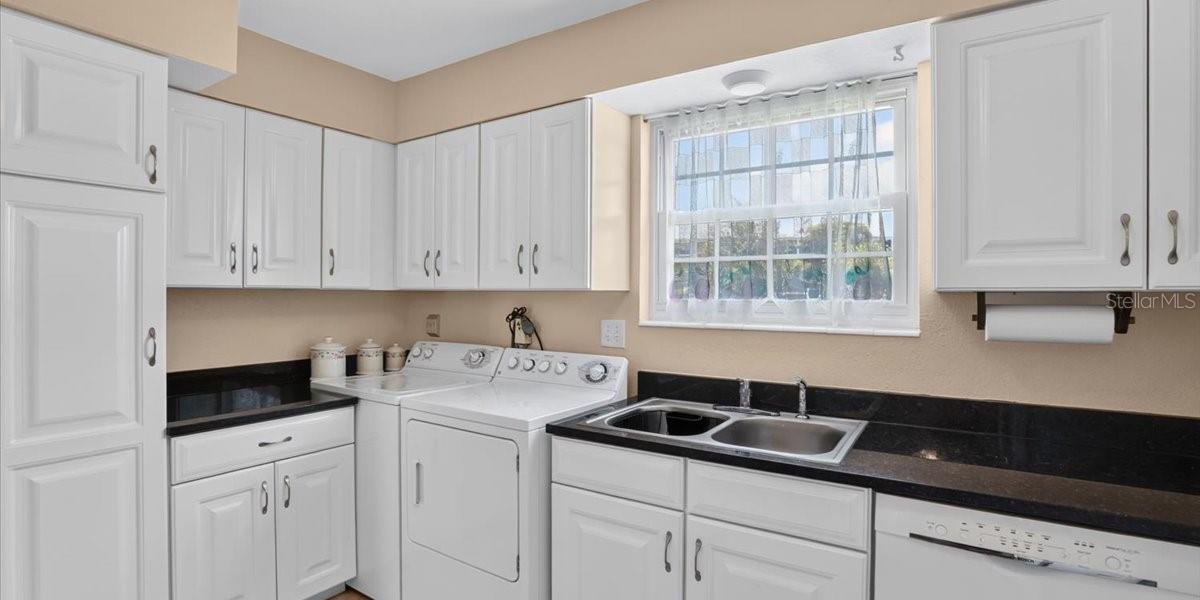 Yet another view of kitchen wih white cabinets that offer spacious storage