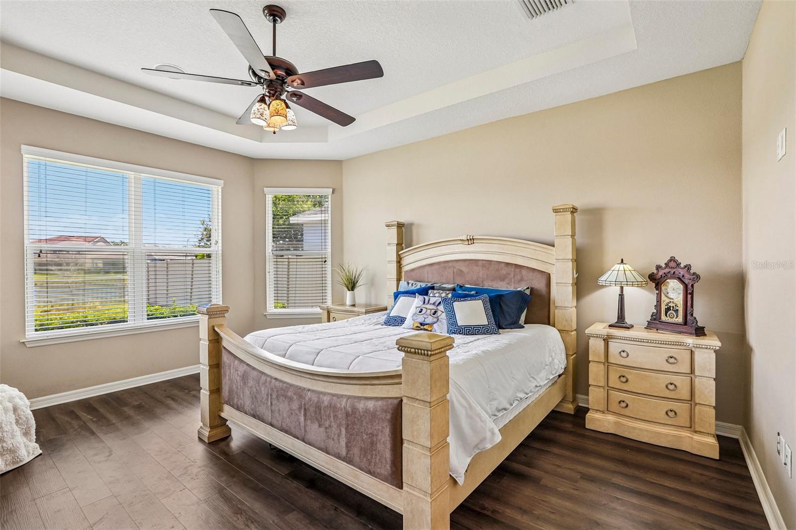 Primary Bedroom with new laminate flooring, view to the back yard and pond