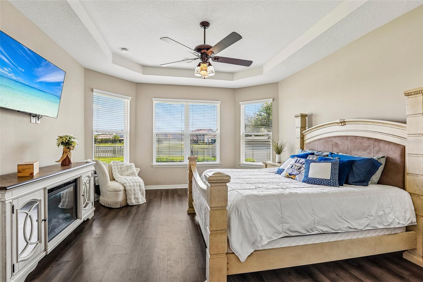 Primary Bedroom with new laminate flooring, view to the back yard and pond