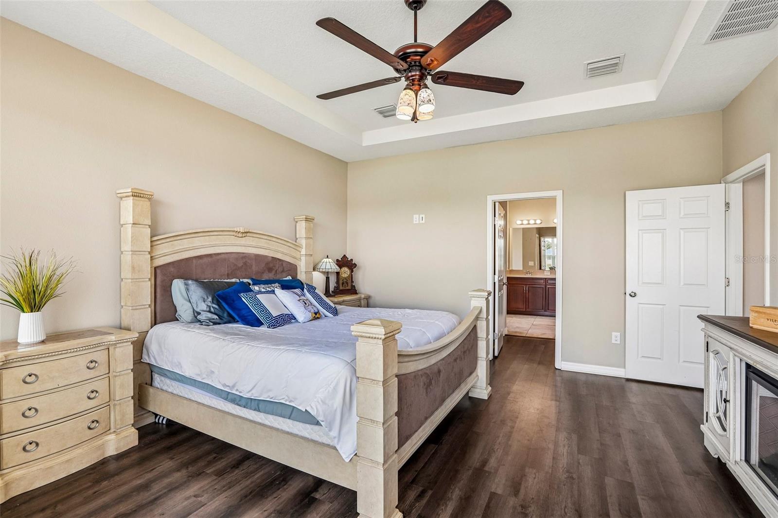 Primary Bedroom with new laminate flooring, view to the back yard and pond