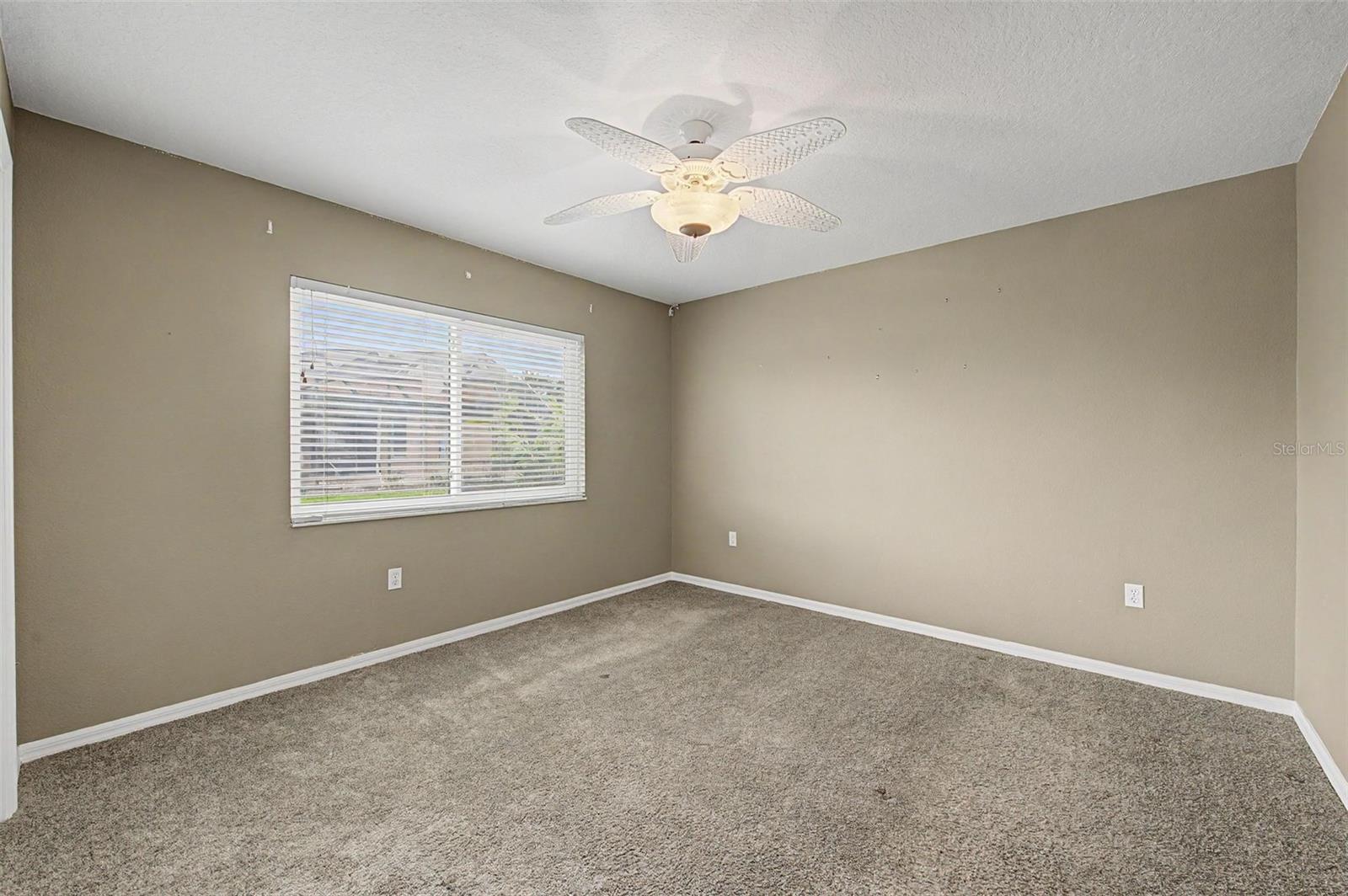 Spacious third bedroom featuring a comfortable layout, abundant natural light, and ample closet space.