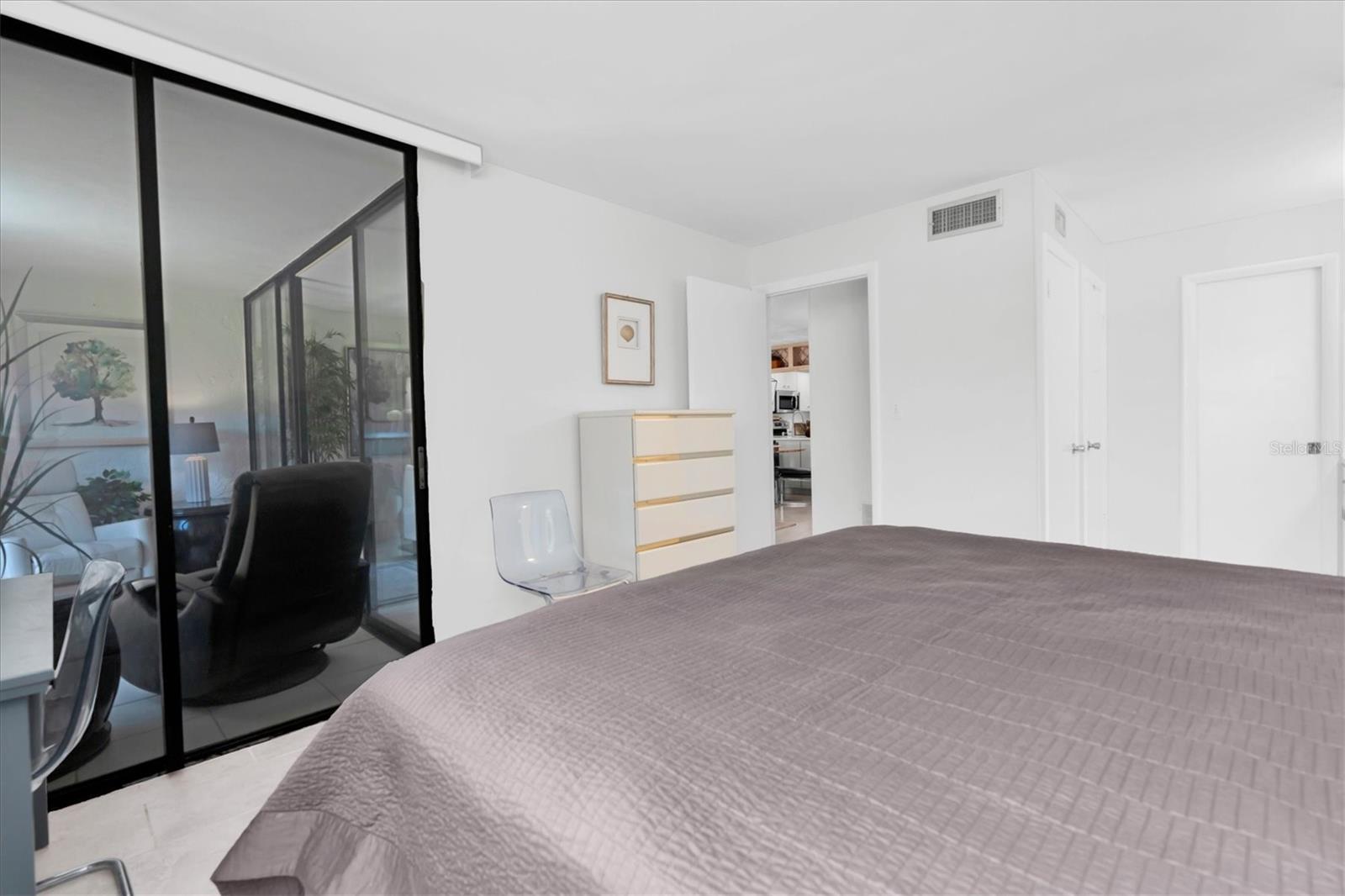 Primary Bedroom - patio door to Florida Room. Bedroom door leads to living room