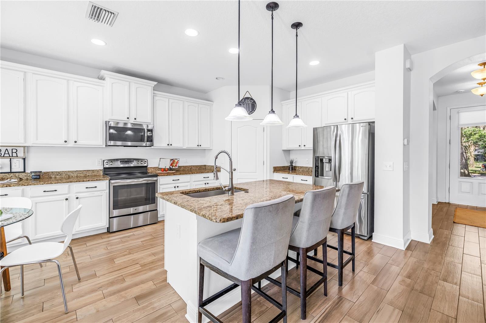 KITCHEN OPEN TO FAMILY ROOM ISLAND