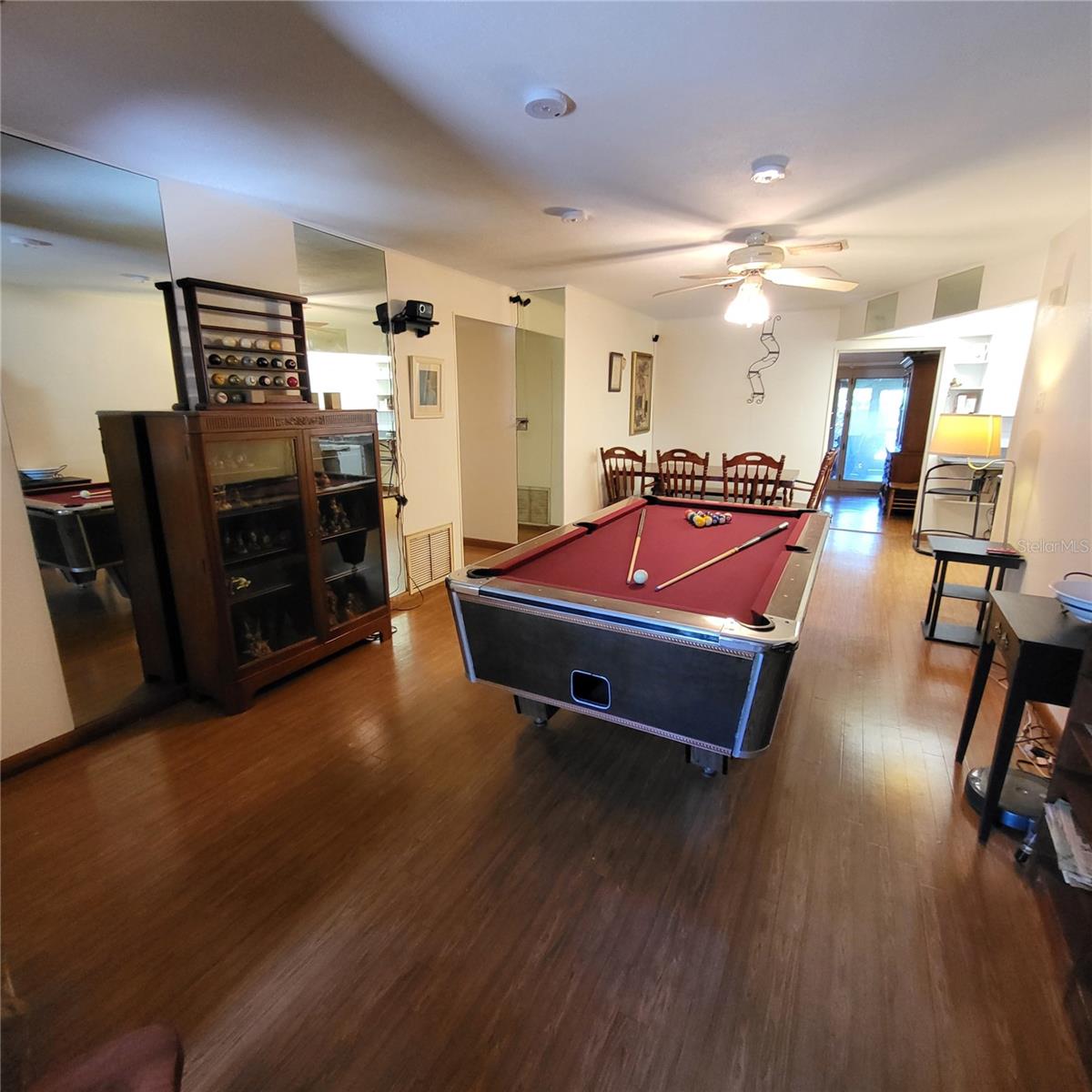 View from front to back shows entrance to formal dining area with access door to back patio.