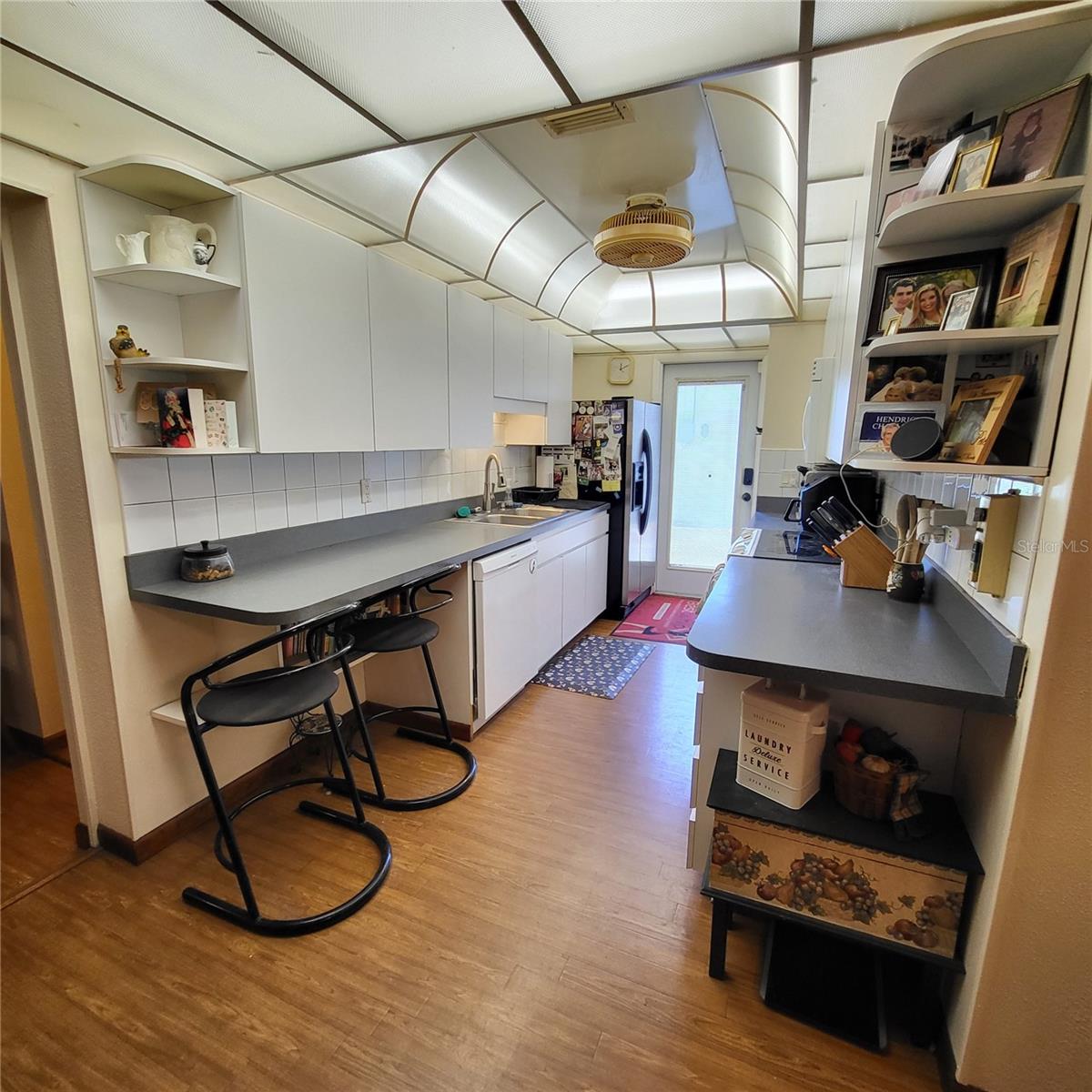 Kitchen is situated just off living room & breakfast nook offers a desk and built-in shelving.