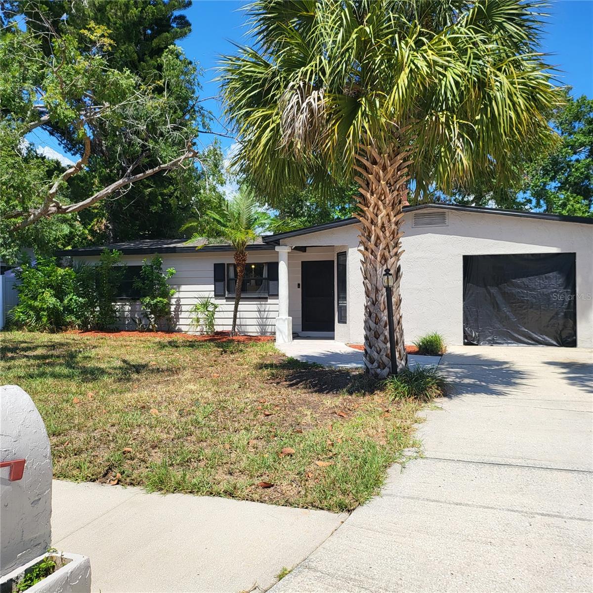 Freshly cleaned driveway, sidewalk and entry.  Fully enclosed carport just needs a door to make it a secure garage!