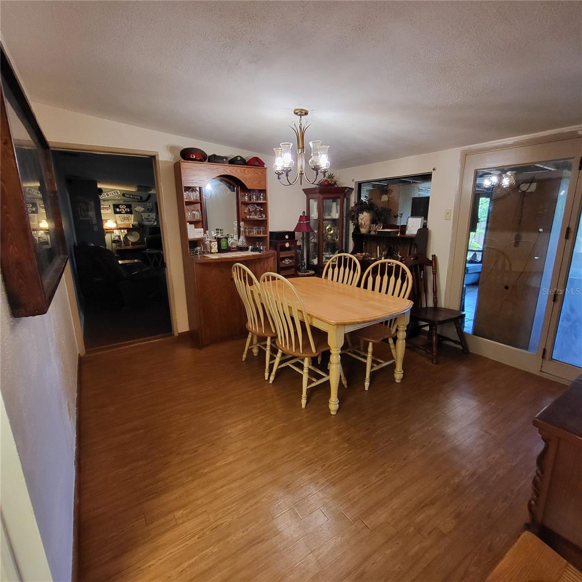 Formal Dining area/bar is situated between the Living Room/Kitchen and Family room that can be closed off with a pocket sliding door.