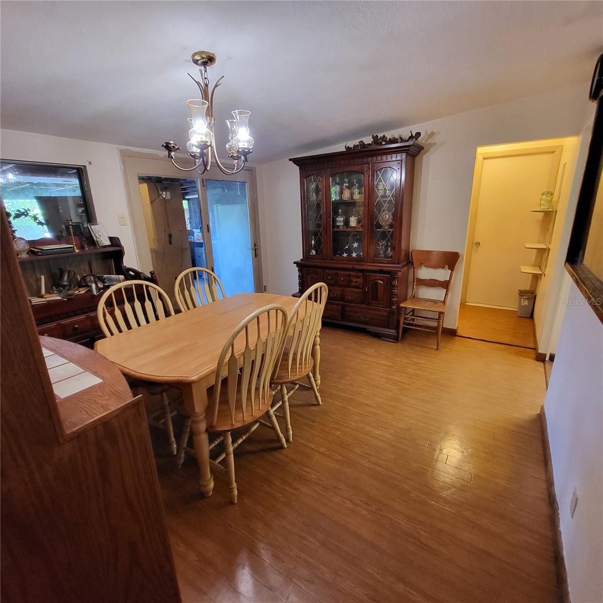 Formal dining area has glass access door to back patio.  Hallway leads to second bathroom and utility room.