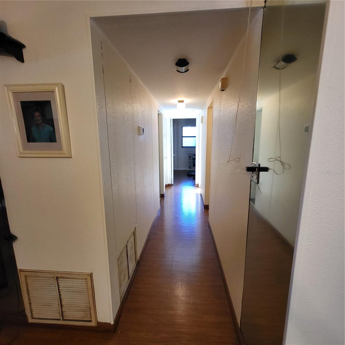 Main hallway from living room to 3 bedrooms, guest room/office & bathroom.