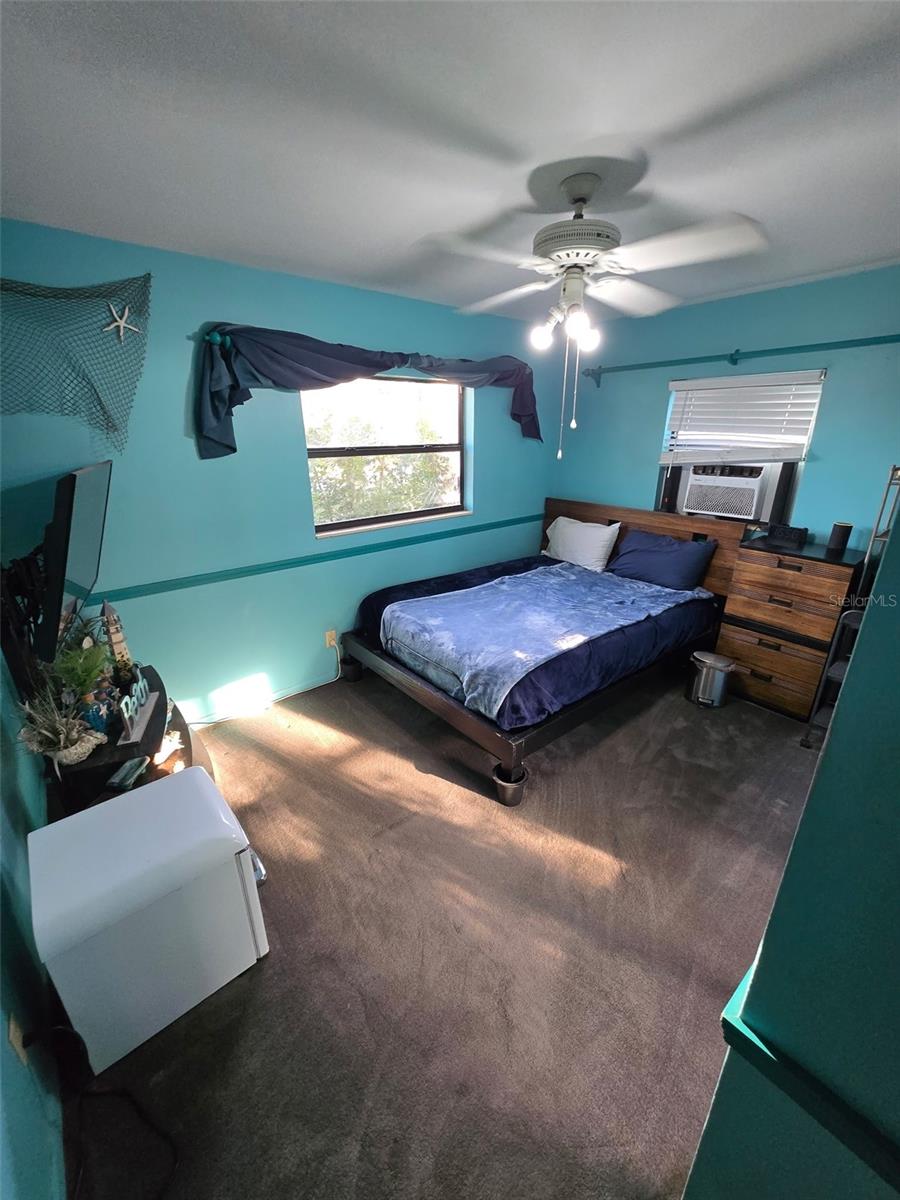 Bedroom two (currently primary bedroom), situated at the front corner of the house, is spacious and offers an additional AC for added convenience.