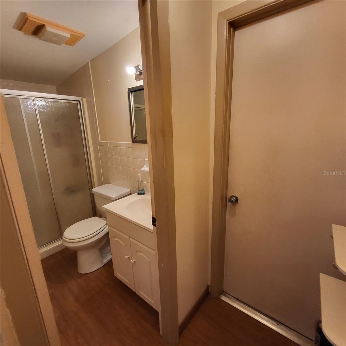 Hallway into second bathroom and Utility room