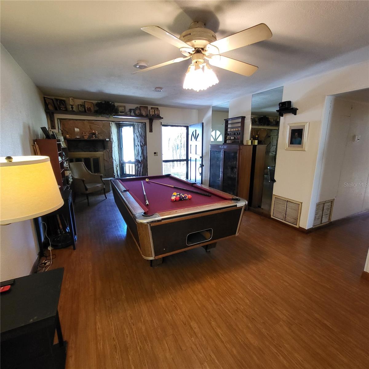 Enter through front door into large open living/dining room currently set up as a recreation room.