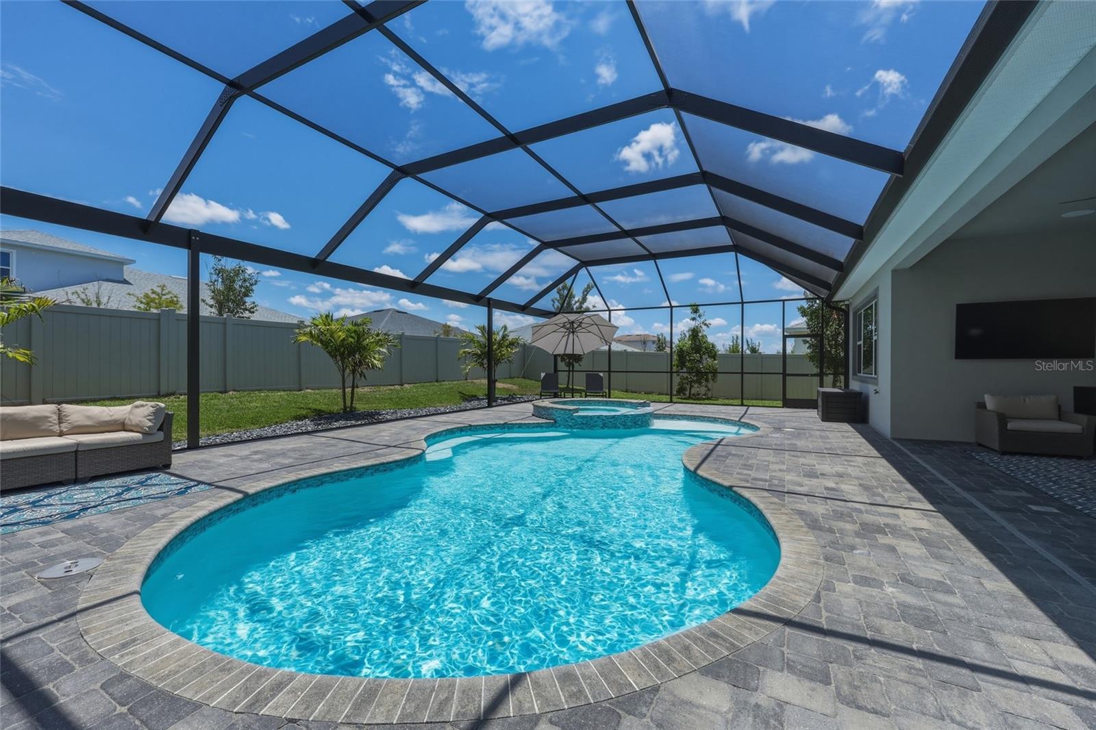 Resort-style Saltwater Pool with Spa, Extra Large Paver Patio, and Fenced-in Yard
