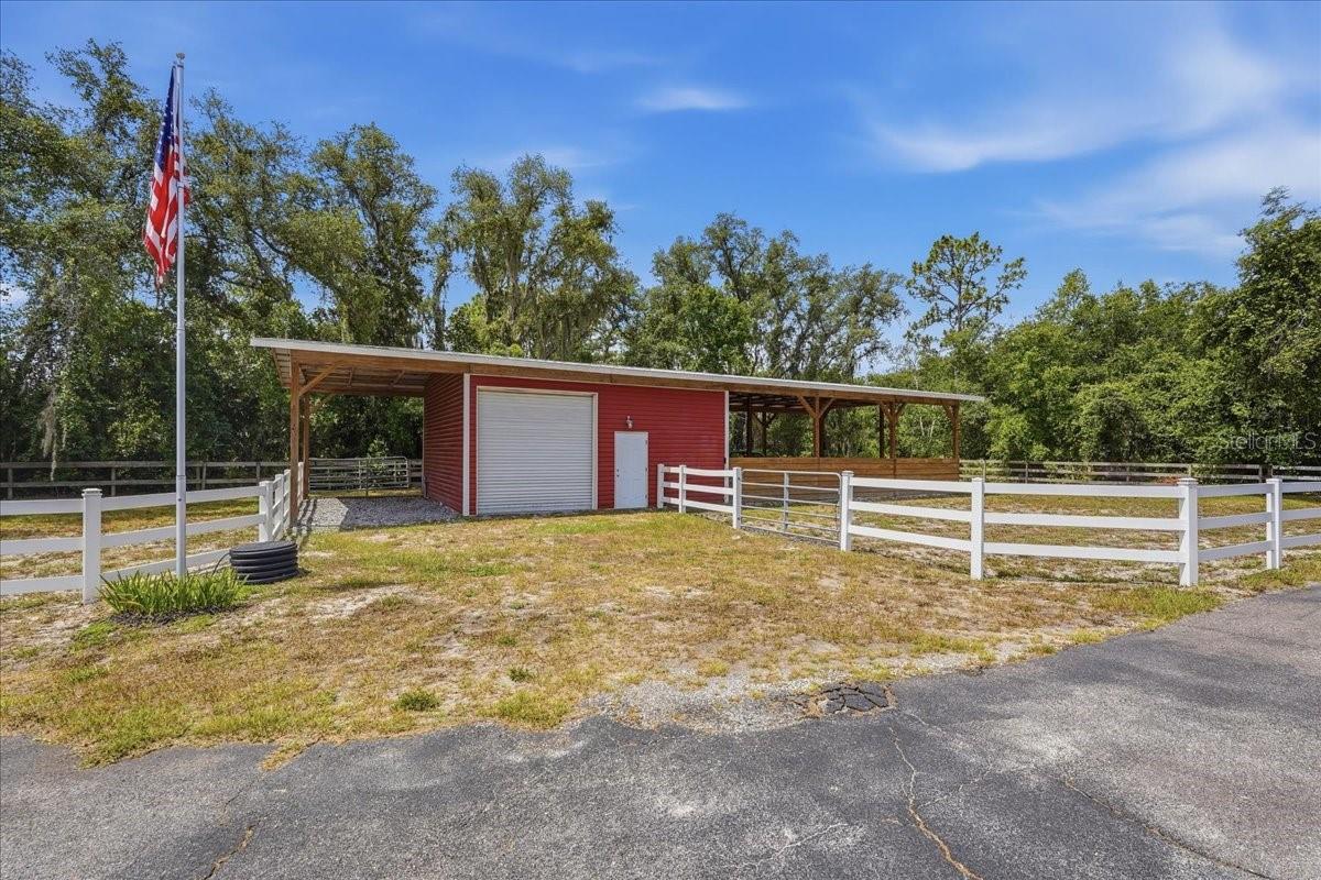 Barn with tack room and 3 stalls. Extra carport area