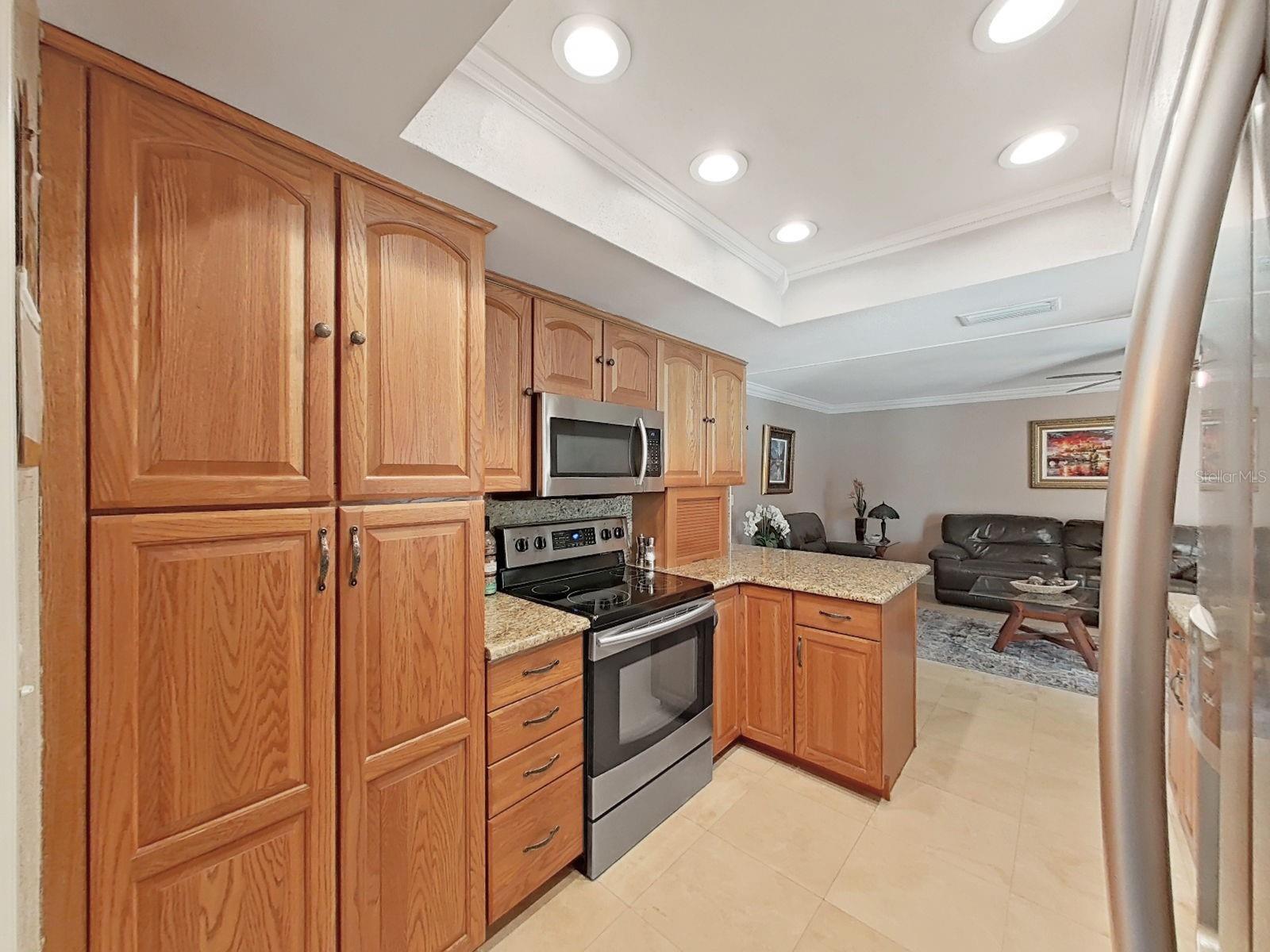 Oak Cabinets, Granite counter tops and Travertine tile, recessed lighting and cove moldings!