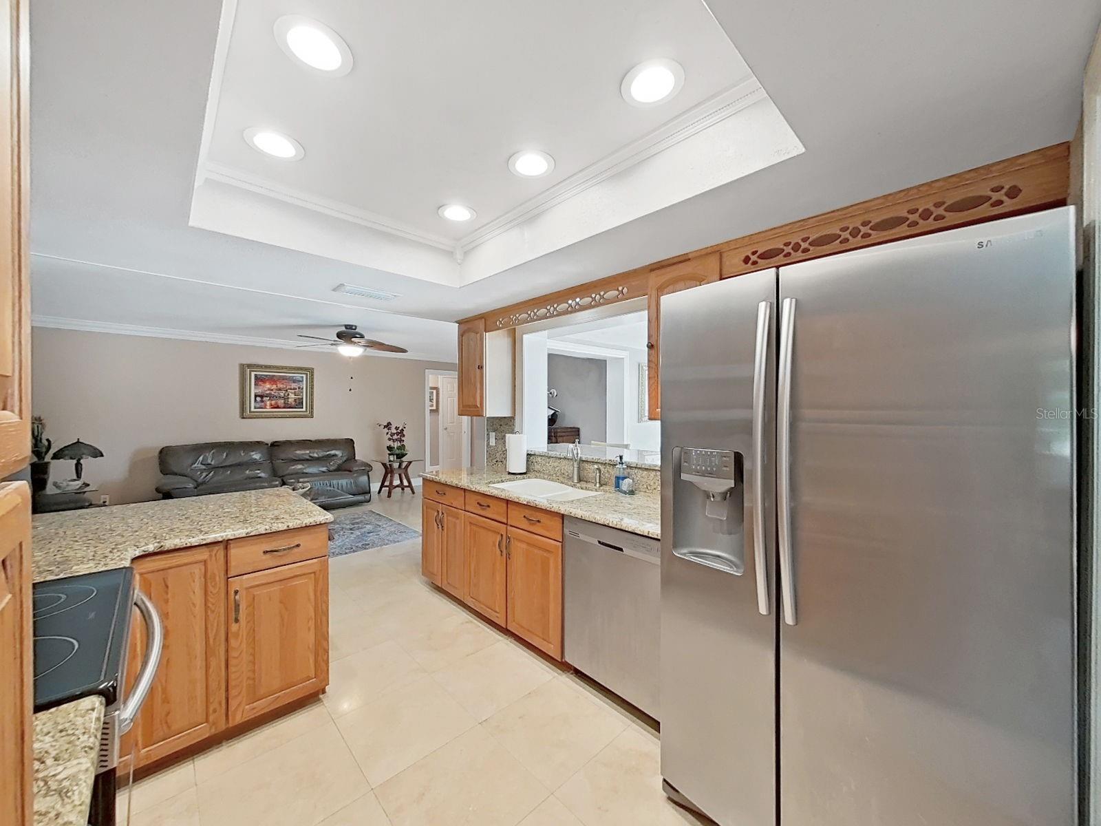 Entertainment friendly floor plan! Pass through window to the sunlit Florida room overlooking the sparkling pool!