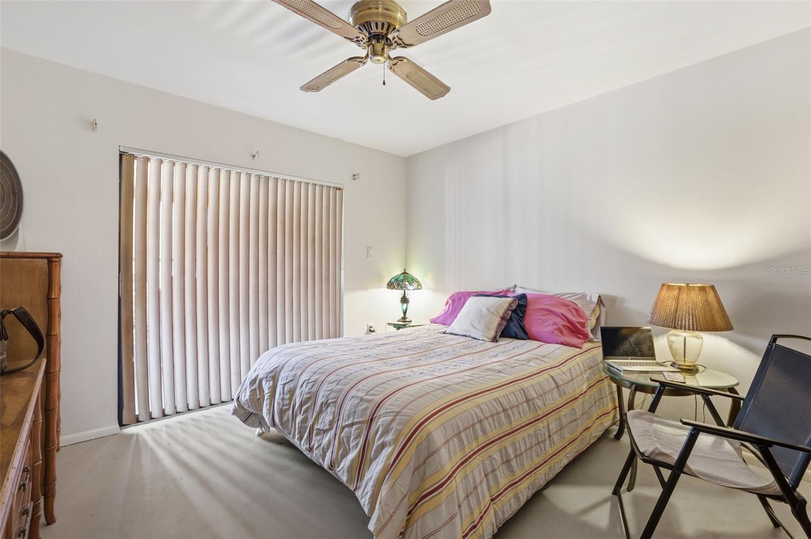 The second bedroom features sliders to the lanai and a walk in closet