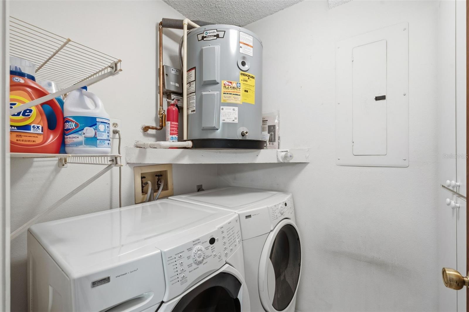 Laundry room and pantry with a newer water heater