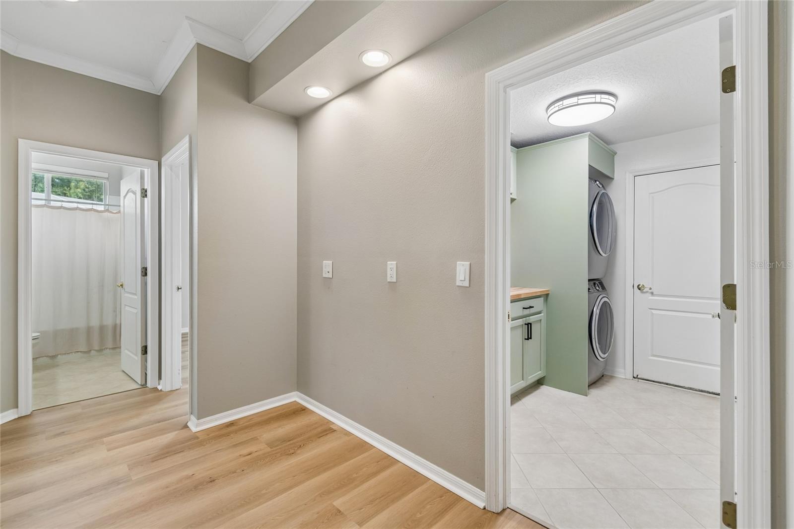 Hallway to laundry room, garage, 2 bedrooms & full bath