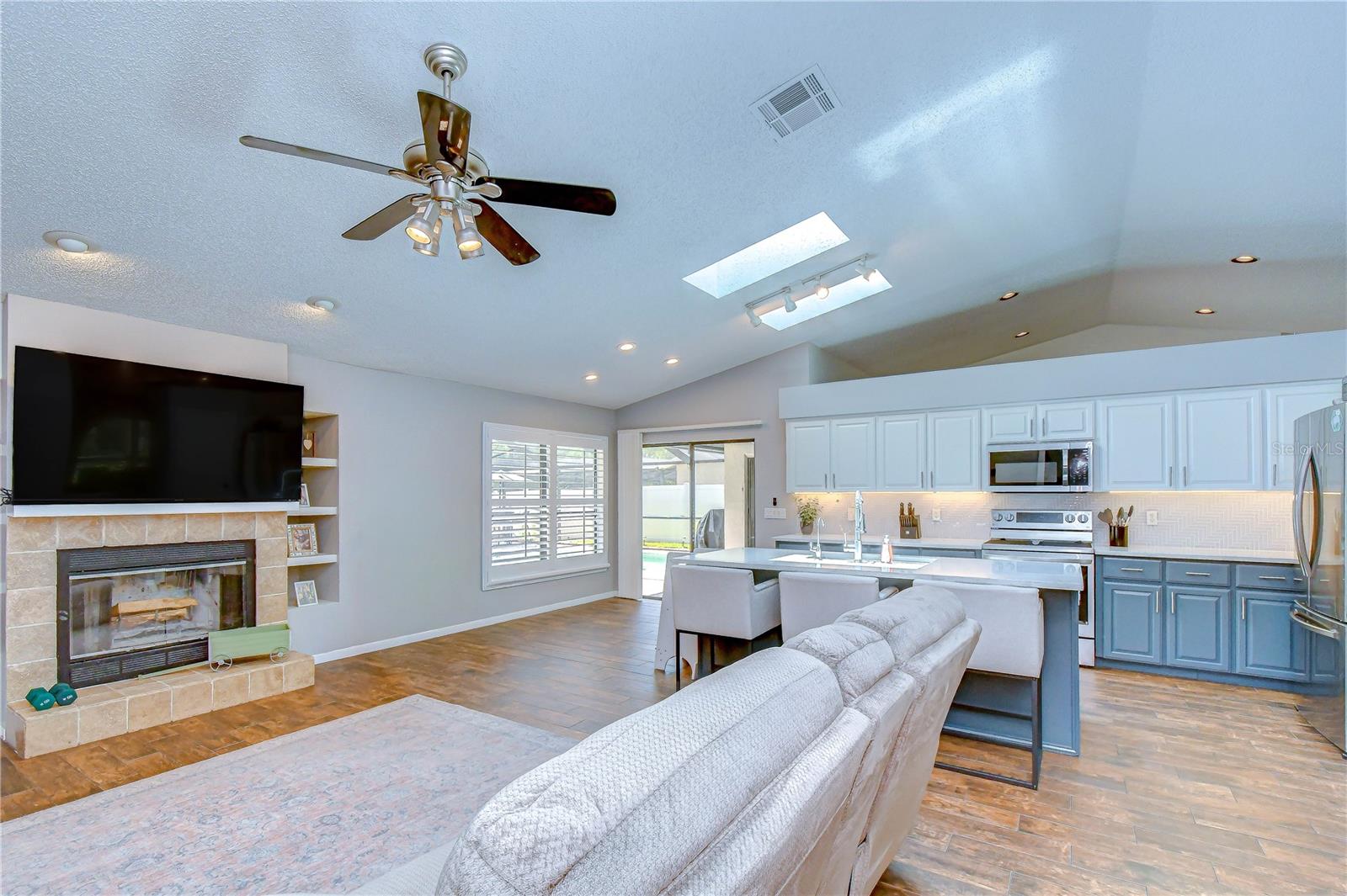 Comfortable gathering space centered around a wood-burning fireplace.