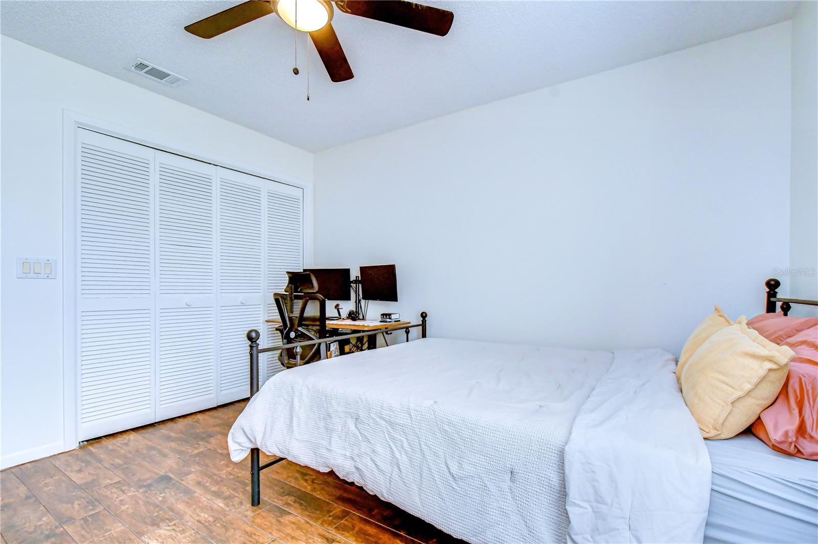 Comfortable guest bedroom with abundant natural light.