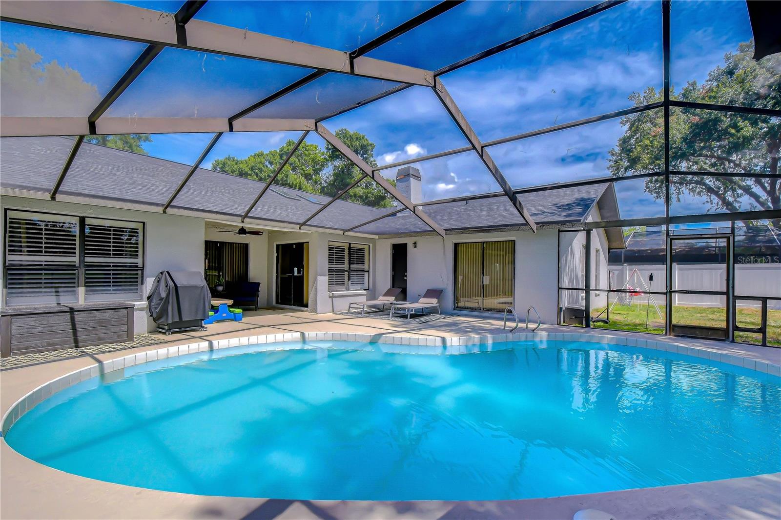 Covered screened lanai perfect for year-round Florida living.